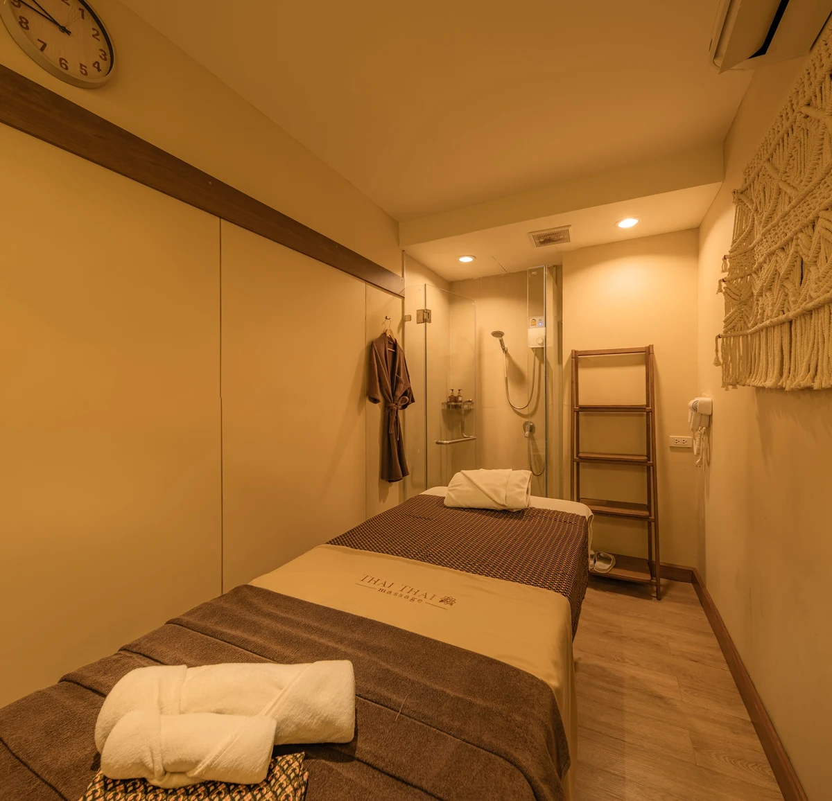 Private treatment room with a low bed and folded robe at ThaiThai Massage flagship on Siam Square Soi 6, a massage in Siam Bangkok