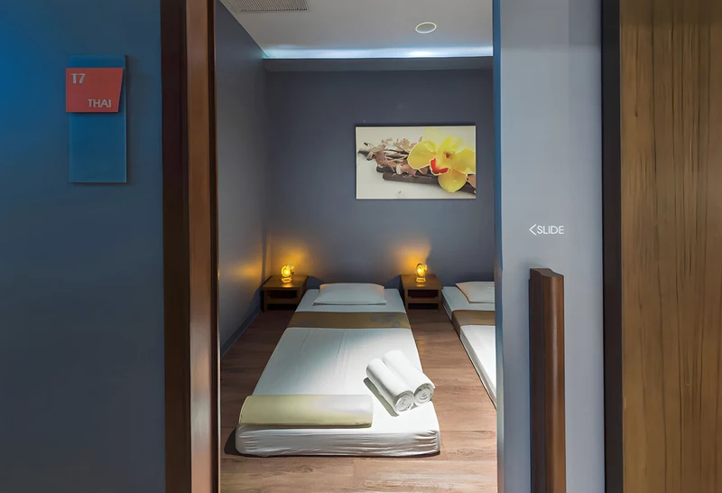 Twin massage beds in a blue-walled treatment room at Let's Relax Spa in Siam Square One, a massage in Siam Bangkok